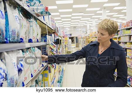Stock Photography - Woman shopping in a supermarket. Fotosearch