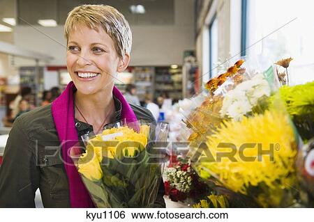 Woman smiling in a florist shop View Large Photo Image Stock Photograph - Woman smiling in a florist shop. Fotosearch