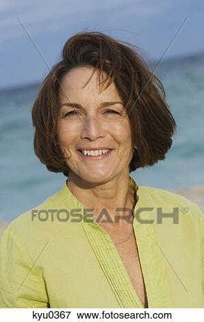 Woman smiling on the beach View Large Photo Image Stock Photo - Woman smiling on the beach. Fotosearch