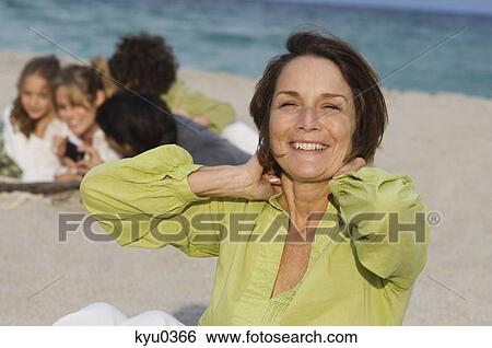 Woman smiling on the beach View Large Photo Image Stock Photograph - Woman smiling on the beach. Fotosearch
