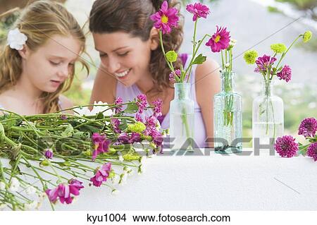 Woman smiling with her daughter View Large Photo Image Picture - Woman smiling with her daughter. Fotosearch