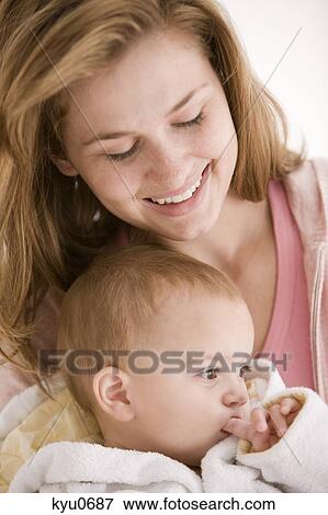 Stock Photo - Woman smiling with her daughter. Fotosearch