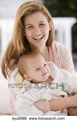 Woman smiling with her daughter View Large Photo Image Stock Photo - Woman smiling with her daughter. Fotosearch