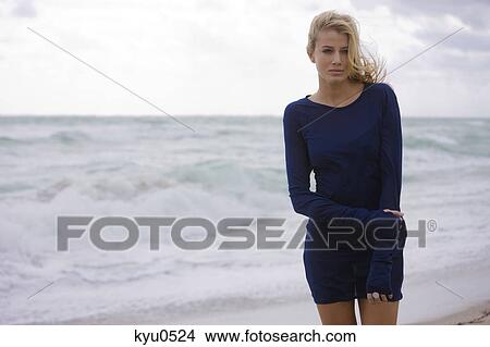 Woman standing on the beach View Large Photo Image Picture - Woman standing on the beach. Fotosearch
