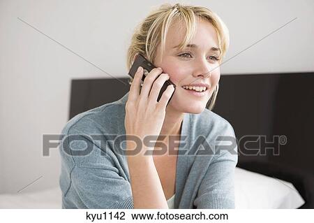 Woman talking on a mobile phone View Large Photo Image Stock Image - Woman talking on a mobile phone. Fotosearch