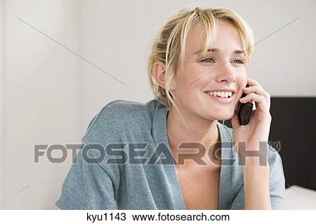 Woman talking on a mobile phone View Large Photo Image Stock Image - Woman talking on a mobile phone. Fotosearch