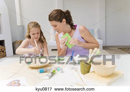Stock Photo - Woman teaching her daughter. Fotosearch