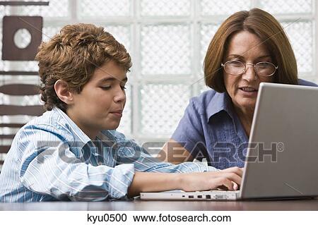 Stock Image - Woman teaching her grandson. Fotosearch