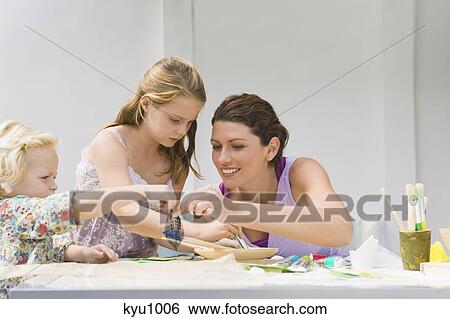 Stock Photograph - Woman teaching her two daughters. Fotosearch