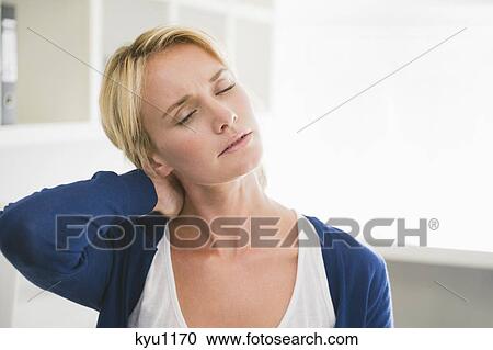Stock Image - Woman touching her neck. Fotosearch