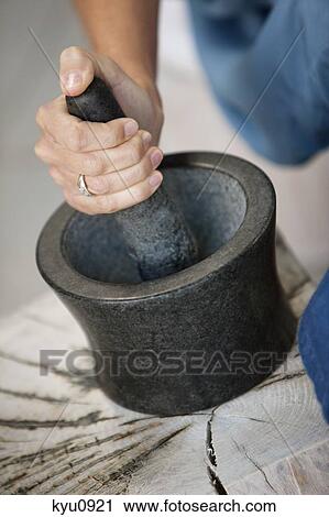 Woman using mortar and pestle View Large Photo Image Stock Image - Woman using mortar and pestle. Fotosearch