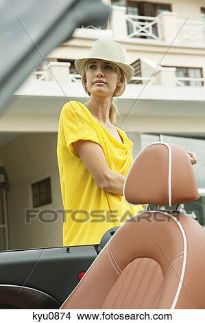 Woman waiting near a car at the roadside View Large Photo Image Picture - Woman waiting near a car at the roadside. Fotosearch