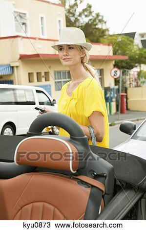 Woman waiting near a car View Large Photo Image Stock Image - Woman waiting near a car. Fotosearch