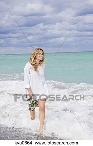 Woman walking on the beach View Large Photo Image Picture - Woman walking on the beach. Fotosearch