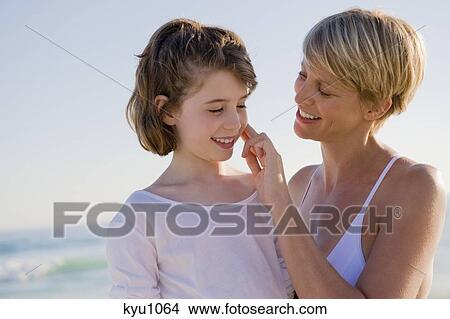 Woman with her daughter enjoying vacations on the beach View Large Photo Image Picture - Woman with her daughter enjoying vacations on the beach. Fotosearch