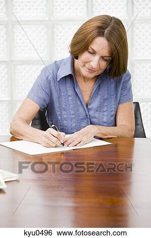 Woman writing in a notebook View Large Photo Image Stock Photograph - Woman writing in a notebook. Fotosearch