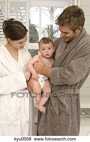 Young couple in bathrobe with baby in bathroom View Large Photo Image Stock Photo - Young couple in bathrobe with baby in bathroom. Fotosearch
