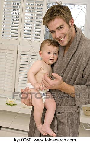 Stock Image - Young smiling man with baby. Fotosearch