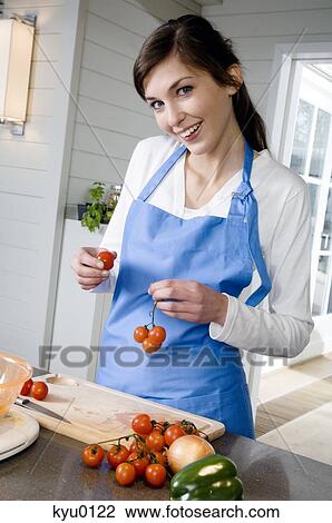 Young smliling woman holding cherry tomatoes View Large Photo Image Stock Image - Young smliling woman holding cherry tomatoes. Fotosearch