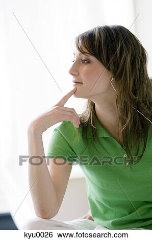 Young thinking woman with earphones View Large Photo Image Stock Photograph - Young thinking woman with earphones. Fotosearch