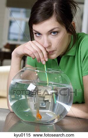 Young woman drinking aquarium water with a straw View Large Photo Image Stock Photography - Young woman drinking aquarium water with a straw. Fotosearch