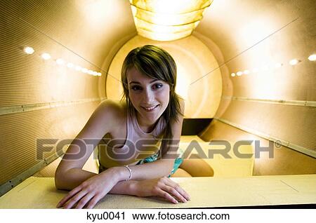 Young woman smiling at the camera, lying in a relaxation box View Large Photo Image Stock Image - Young woman smiling at the camera, lying in a relaxation box. Fotosearch