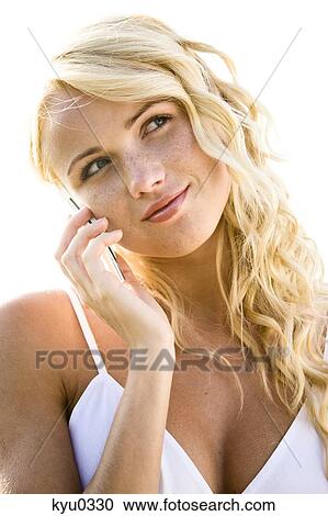 Stock Image - Young woman using her cell. Fotosearch