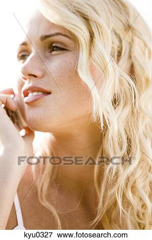 Young woman using her cell View Large Photo Image Stock Photo - Young woman using her cell. Fotosearch