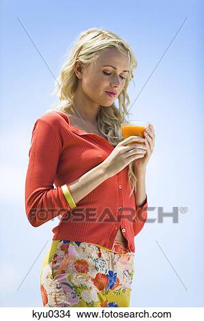 Picture - Young woman with fruit juice. Fotosearch