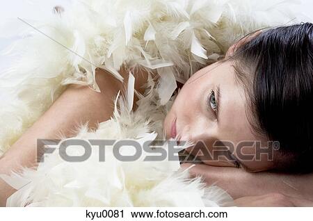 Young woman with white feather boa View Large Photo Image Stock Image - Young woman with white feather boa. Fotosearch