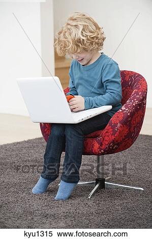 Boy playing with a mobile phone View Large Photo Image Stock Photography - Boy playing with a mobile phone. Fotosearch