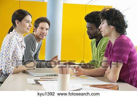 Business executives discussing in an office View Large Photo Image Stock Image - Business executives discussing in an office. Fotosearch