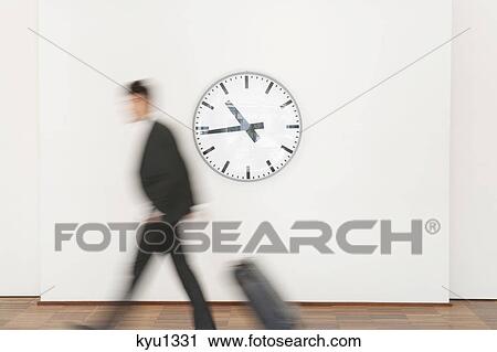 Businessman carrying his luggage View Large Photo Image Stock Image - Businessman carrying his luggage. Fotosearch