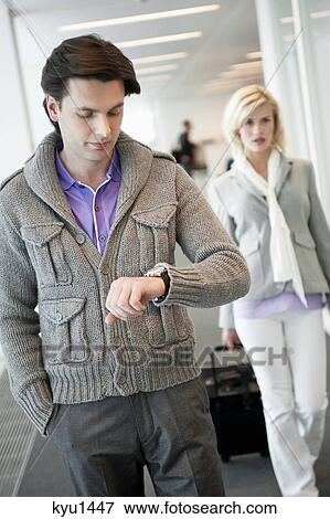 Businessman checking the time View Large Photo Image Stock Photo - Businessman checking the time. Fotosearch