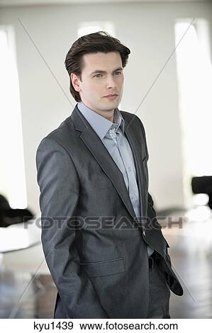 Businessman standing with his hands in his pocket View Large Photo Image Stock Photo - Businessman standing with his hands in his pocket. Fotosearch