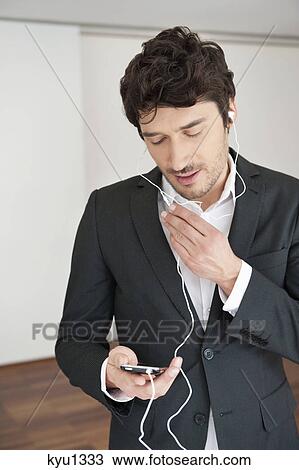 Businessman talking on a mobile phone View Large Photo Image Stock Image - Businessman talking on a mobile phone. Fotosearch