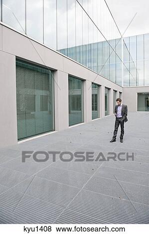 Businessman text messaging on a mobile phone View Large Photo Image Stock Photo - Businessman text messaging on a mobile phone. Fotosearch