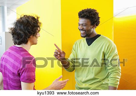 Businessmen smiling in an office View Large Photo Image Stock Image - Businessmen smiling in an office. Fotosearch