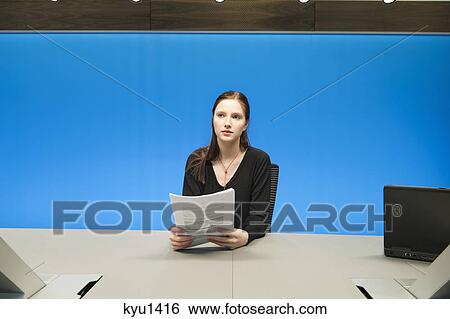 Businesswoman doing paperwork in a conference room View Large Photo Image Stock Photograph - Businesswoman doing paperwork in a conference room. Fotosearch