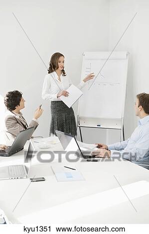 Businesswoman giving presentation in a meeting View Large Photo Image Stock Image - Businesswoman giving presentation in a meeting. Fotosearch