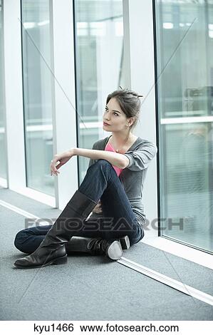 Businesswoman sitting in an office corridor View Large Photo Image Stock Photograph - Businesswoman sitting in an office corridor. Fotosearch