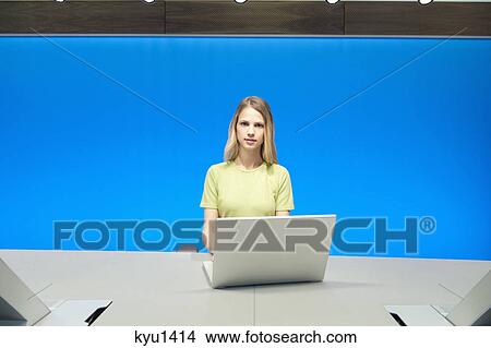 Businesswoman working on a laptop in a conference room View Large Photo Image Picture - Businesswoman working on a laptop in a conference room. Fotosearch