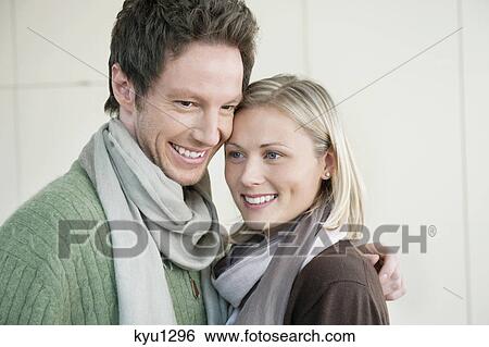 Close-up of a couple smiling View Large Photo Image Stock Photograph - Close-up of a couple smiling. Fotosearch