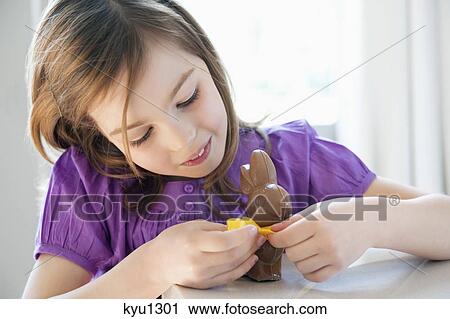 Stock Image - Close-up of a girl playing with an Easter bunny. Fotosearch
