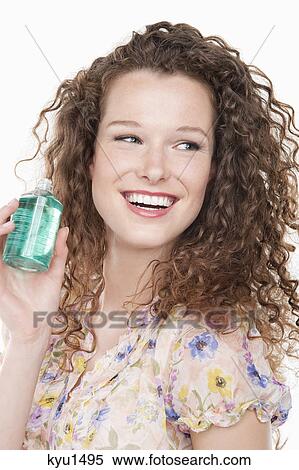 Close-up of a woman holding a bottle of aromatherapy oil View Large Photo Image Stock Photography - Close-up of a woman holding a bottle of aromatherapy oil. Fotosearch
