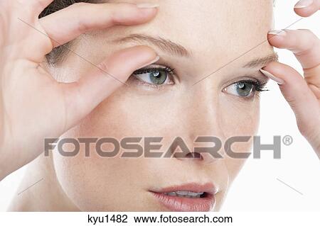 Close-up of a woman massaging eyebrows View Large Photo Image Stock Image - Close-up of a woman massaging eyebrows. Fotosearch