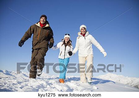 Couple and daughter in ski wear walking in snow View Large Photo Image Stock Photography - Couple and daughter in ski wear walking in snow. Fotosearch