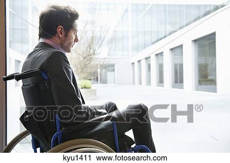 Stock Image - Disabled businessman sitting in a wheelchair. Fotosearch