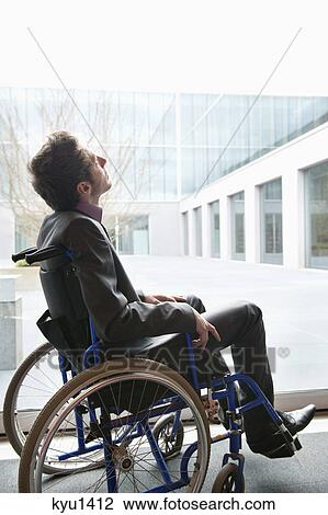 Stock Image - Disabled businessman sitting in a wheelchair. Fotosearch