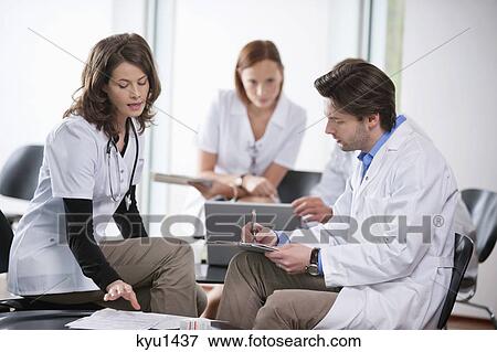 Stock Photo - Doctors discussing together. Fotosearch